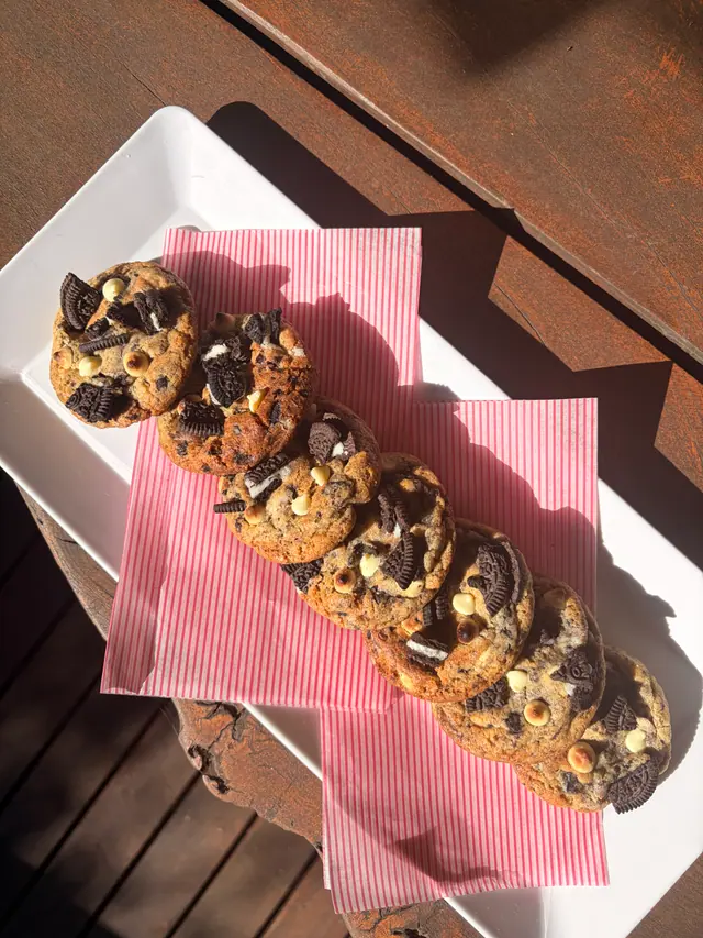An overhead outdoor photo of Cookies & Cream signature cookies.