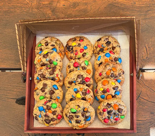 An overhead view of M and M choc chunk cookies arranged in a tray.